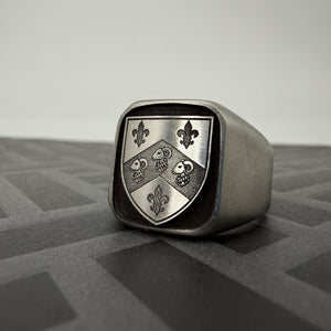 Custom stainless steel signet ring engraved with a family crest